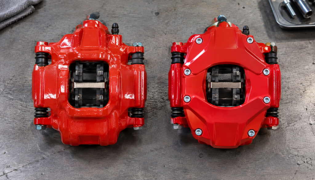Painted brake caliper next to a bolt-on caliper cover comparison"